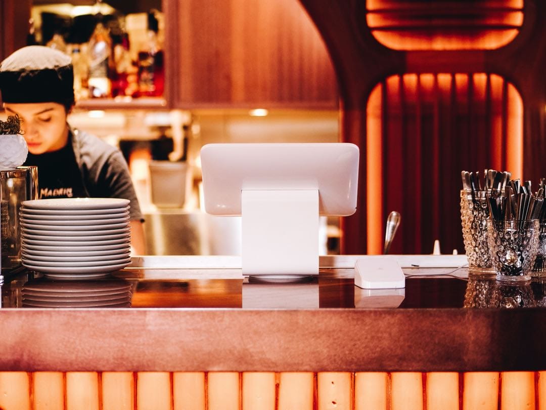 Restaurant or Coffee Shop with happy barista server with pastries, cake and customers