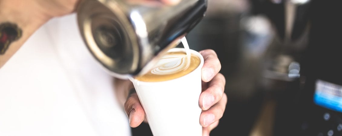 barista pouring latte art, cafe