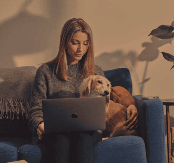 work from home female and dog with laptop